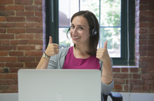 Employee at a laptop and wearing headset